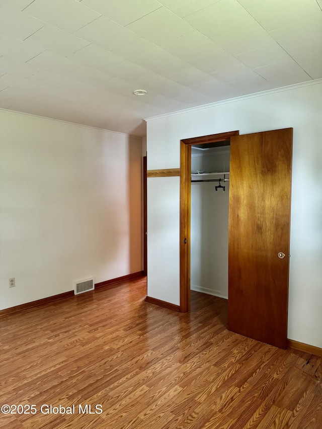 210 County Route 44, Argyle, NY 12809 - unfurnished bedroom with wood finished floors, ornamental molding, a closet, and baseboards