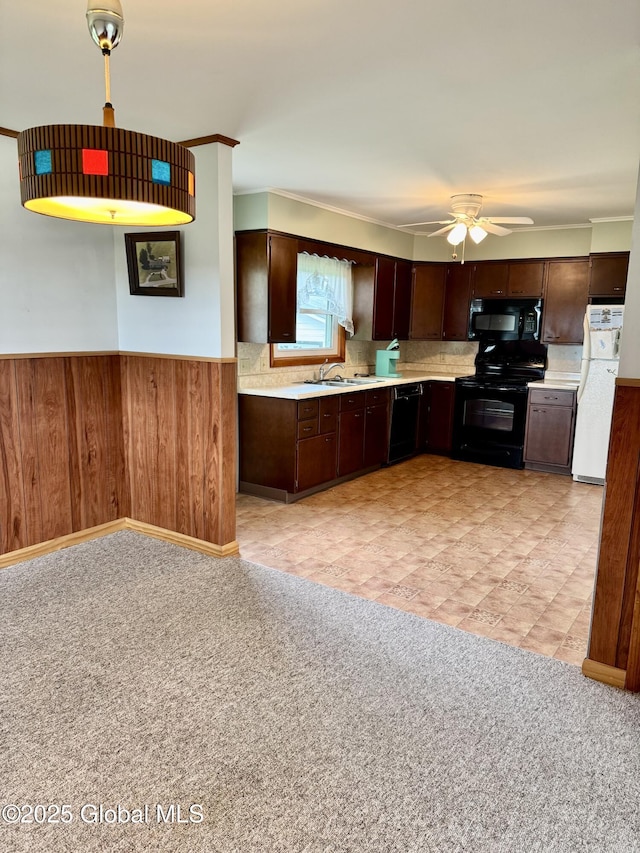210 County Route 44, Argyle, NY 12809 - kitchen featuring black appliances, light countertops, a sink, dark brown cabinetry, and a wainscoted wall