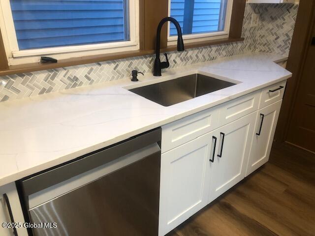 50 Mapleridge Ave, Albany, NY 12209 - kitchen with stainless steel dishwasher, a sink, light stone countertops, and decorative backsplash