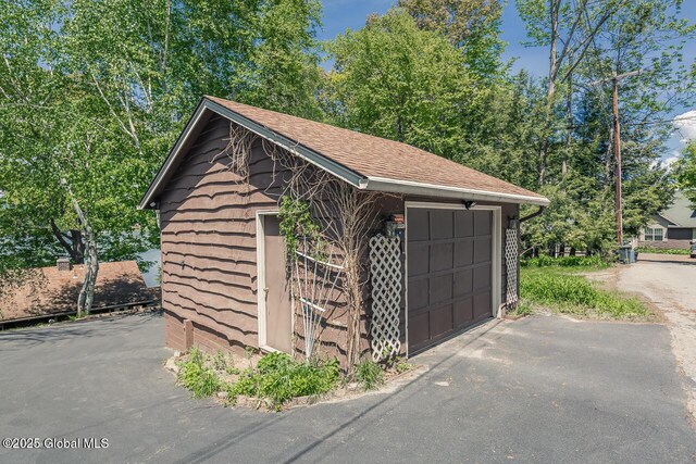 241 Kunkel Rd, Mayfield, NY 12117 - detached garage featuring asphalt driveway