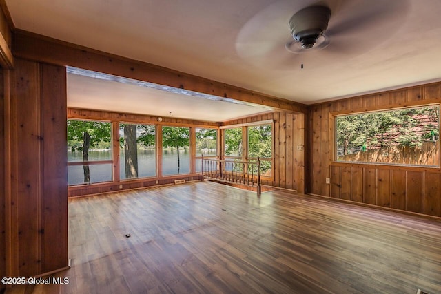 241 Kunkel Rd, Mayfield, NY 12117 - spare room with a water view, ceiling fan, wooden walls, and wood finished floors