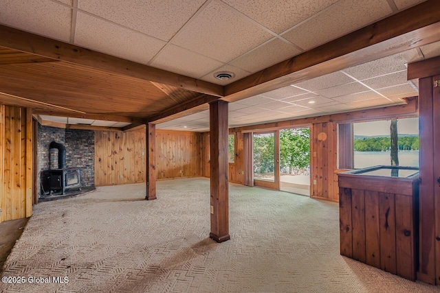 241 Kunkel Rd, Mayfield, NY 12117 - interior space with a wood stove, wood walls, carpet flooring, and a paneled ceiling