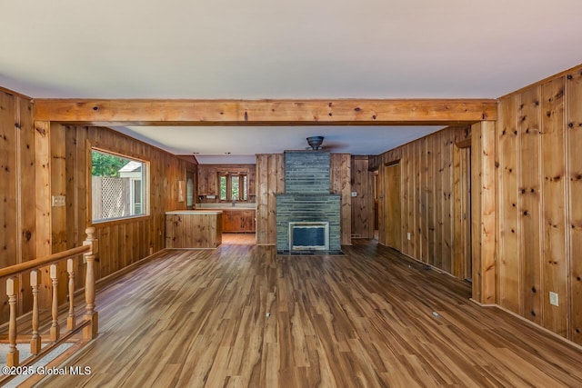 241 Kunkel Rd, Mayfield, NY 12117 - unfurnished living room with dark wood finished floors, wooden walls, and beamed ceiling
