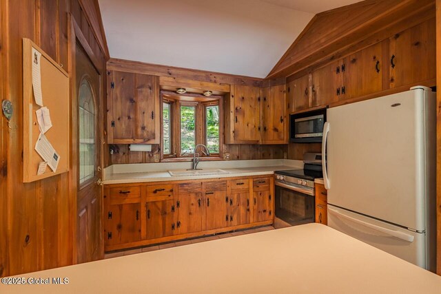 241 Kunkel Rd, Mayfield, NY 12117 - kitchen featuring stainless steel appliances, a sink, vaulted ceiling, light countertops, and brown cabinets