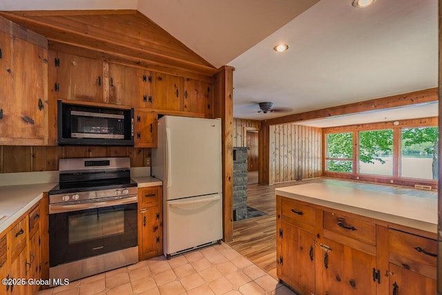 241 Kunkel Rd, Mayfield, NY 12117 - kitchen with stainless steel appliances, brown cabinets, lofted ceiling, and recessed lighting