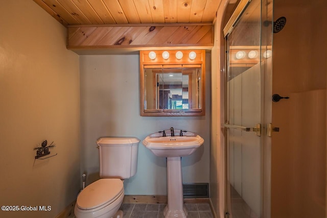 241 Kunkel Rd, Mayfield, NY 12117 - bathroom with toilet, tile patterned floors, baseboards, wooden ceiling, and a shower with shower door