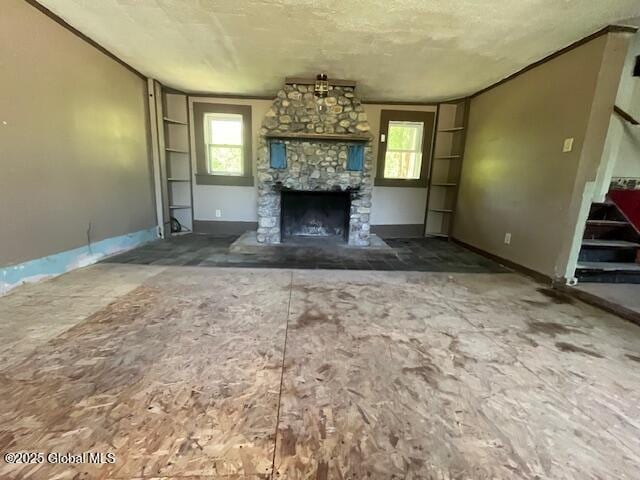 854 Millers Corners Rd, Florida, NY 12053 - unfurnished living room with stairway, healthy amount of natural light, a fireplace, and baseboards