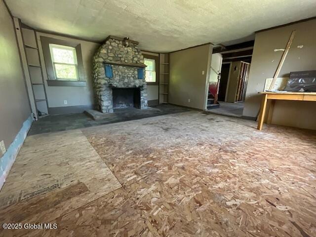 854 Millers Corners Rd, Florida, NY 12053 - unfurnished living room with a fireplace, a textured ceiling, and baseboards