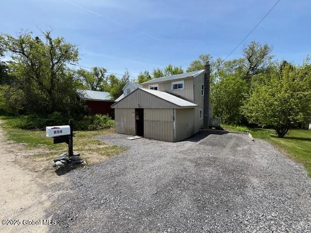 854 Millers Corners Rd, Florida, NY 12053 - view of side of property with driveway, a chimney, and an outbuilding