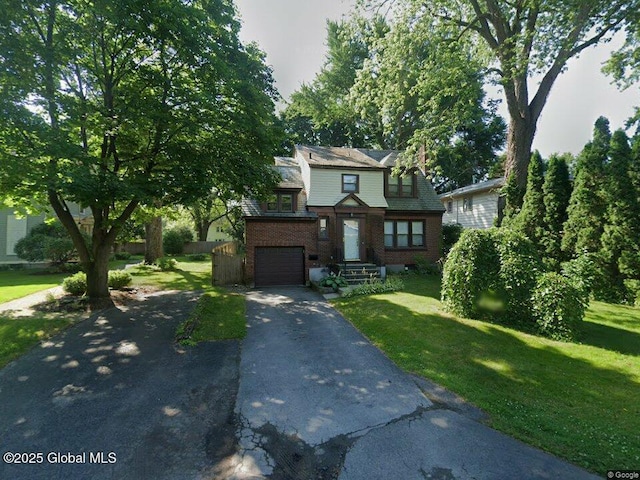 5 Kakely St, Albany, NY 12208 - view of front of property featuring asphalt driveway, a front yard, an attached garage, and brick siding