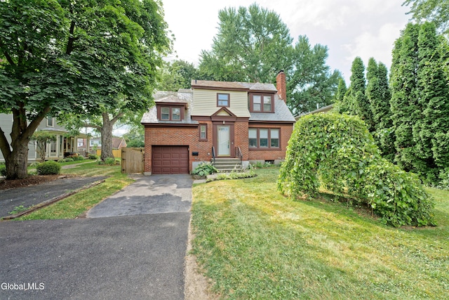 5 Kakely St, Albany, NY 12208 - view of front of home with driveway, a garage, a chimney, brick siding, and a front lawn