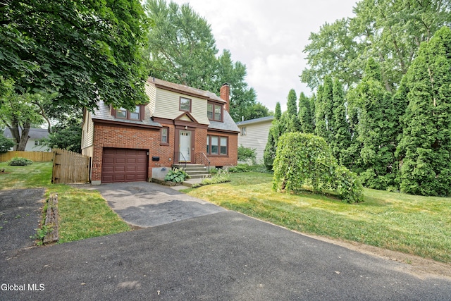 5 Kakely St, Albany, NY 12208 - view of front facade featuring an attached garage, driveway, brick siding, and a chimney