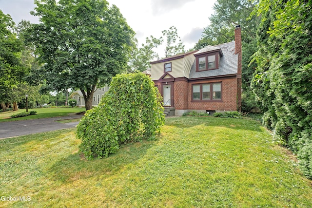 5 Kakely St, Albany, NY 12208 - view of front of property with brick siding, a chimney, and a front lawn