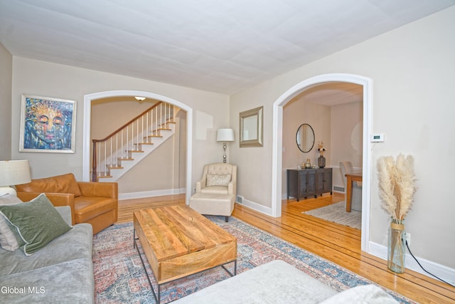 5 Kakely St, Albany, NY 12208 - living area with arched walkways, hardwood / wood-style floors, and stairs