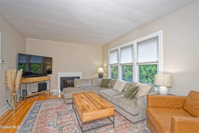 5 Kakely St, Albany, NY 12208 - living room with a brick fireplace and light wood-style floors