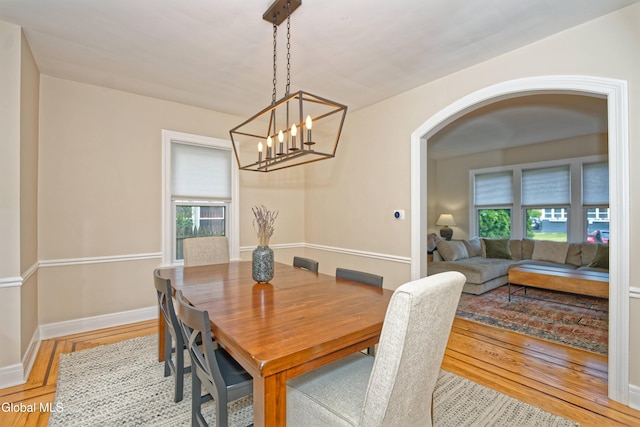 5 Kakely St, Albany, NY 12208 - dining room featuring wood finished floors, arched walkways, and plenty of natural light