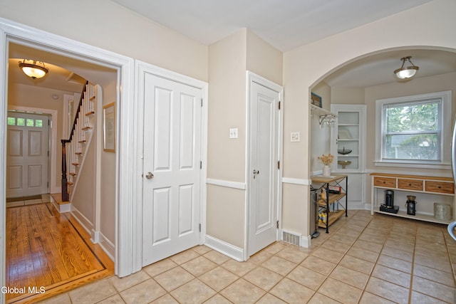 5 Kakely St, Albany, NY 12208 - entryway featuring arched walkways, stairway, and light tile patterned floors