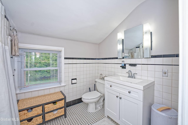 5 Kakely St, Albany, NY 12208 - bathroom featuring tile walls, lofted ceiling, vanity, and a wainscoted wall
