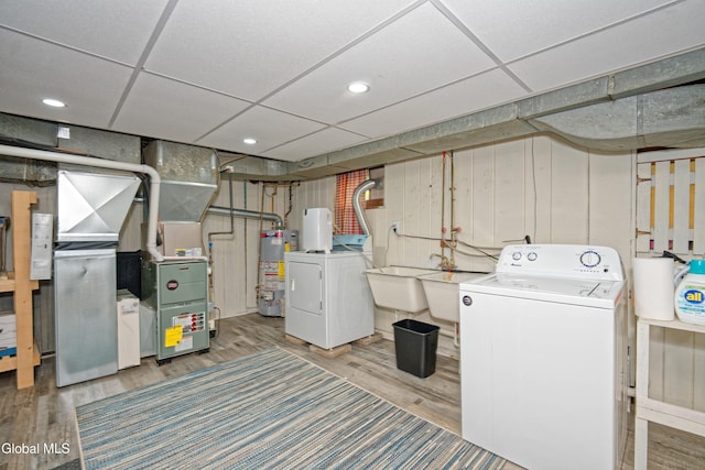 5 Kakely St, Albany, NY 12208 - laundry room with washing machine and dryer, wood finished floors, and water heater