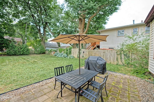 5 Kakely St, Albany, NY 12208 - fenced backyard with area for grilling, a patio, and outdoor dining space