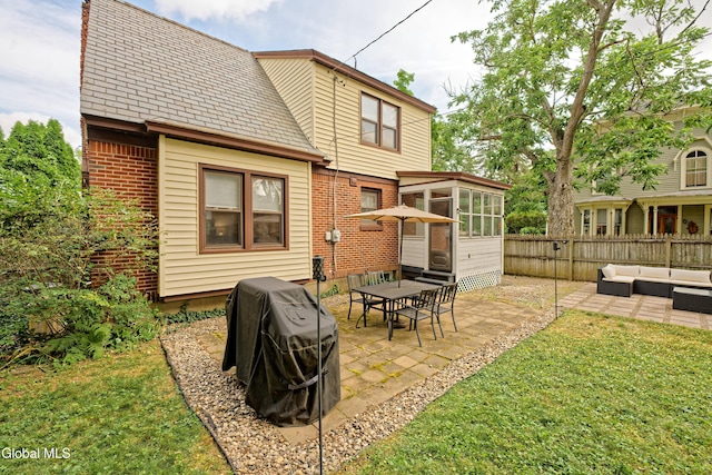 5 Kakely St, Albany, NY 12208 - back of house with a sunroom, an outdoor living space, a patio area, and brick siding