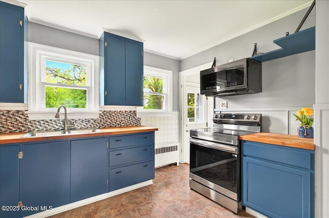 115 E 4th Ave, Mohawk, NY 12068 - kitchen featuring appliances with stainless steel finishes, a sink, radiator, blue cabinets, and crown molding