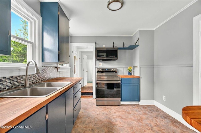 115 E 4th Ave, Mohawk, NY 12068 - kitchen with stainless steel appliances, a sink, butcher block countertops, blue cabinets, and backsplash