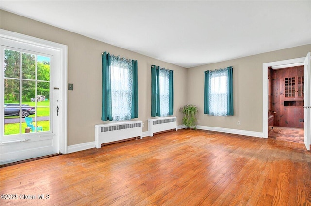 115 E 4th Ave, Mohawk, NY 12068 - empty room featuring radiator heating unit, light wood-type flooring, and baseboards