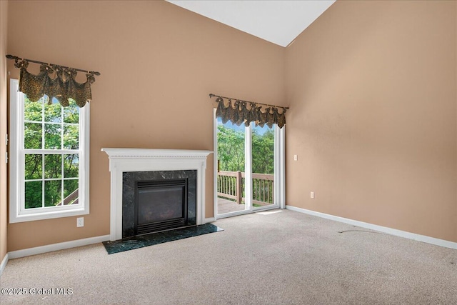 21 Fairway Dr Unit B, Mechanicville, NY 12118 - unfurnished living room with carpet flooring, baseboards, high vaulted ceiling, and a fireplace