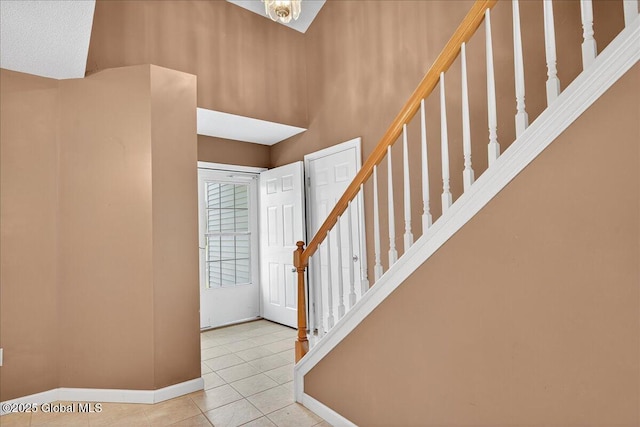 21 Fairway Dr Unit B, Mechanicville, NY 12118 - entrance foyer with tile patterned floors, baseboards, and stairway