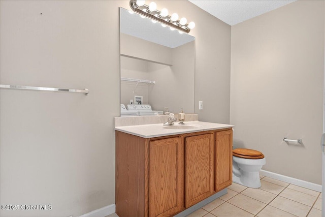 21 Fairway Dr Unit B, Mechanicville, NY 12118 - bathroom featuring washer and clothes dryer, vanity, tile patterned flooring, toilet, and baseboards