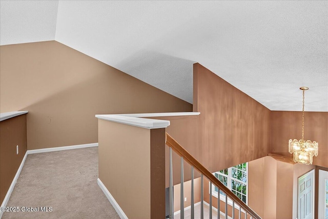 21 Fairway Dr Unit B, Mechanicville, NY 12118 - corridor with an upstairs landing, a chandelier, carpet, vaulted ceiling, and baseboards