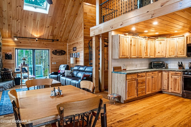 209 Chester Shores Rdg, Chester, NY 12817 - dining room featuring a towering ceiling, light wood-style floors, wooden walls, a skylight, and wooden ceiling