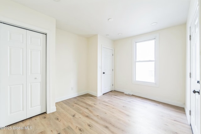 747 Eastern Ave, Schenectady, NY 12308 - unfurnished bedroom with light wood-type flooring, baseboards, and a closet