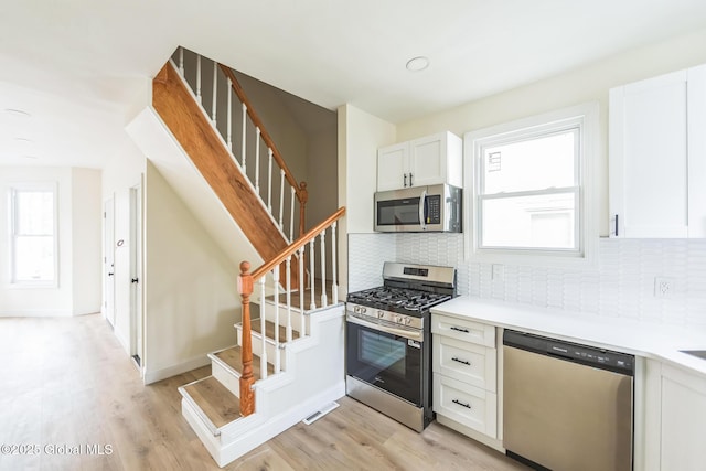 747 Eastern Ave, Schenectady, NY 12308 - kitchen featuring appliances with stainless steel finishes, decorative backsplash, and light wood-style flooring