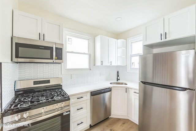 747 Eastern Ave, Schenectady, NY 12308 - kitchen with appliances with stainless steel finishes, a sink, light countertops, white cabinetry, and open shelves