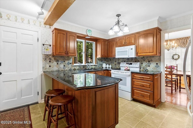 42 Pheasant Ridge Dr, Colonie, NY 12211 - kitchen featuring white appliances, a chandelier, a breakfast bar, brown cabinetry, and decorative backsplash