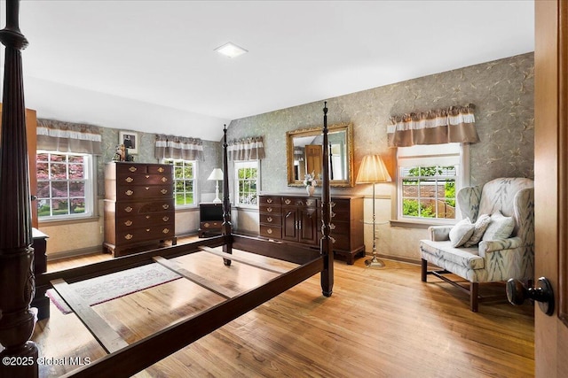 42 Pheasant Ridge Dr, Colonie, NY 12211 - bedroom with wallpapered walls, vaulted ceiling, multiple windows, wood finished floors, and baseboards