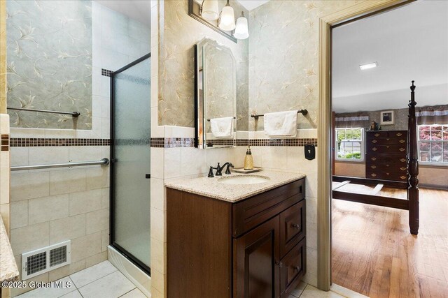 42 Pheasant Ridge Dr, Colonie, NY 12211 - bathroom featuring vanity, a shower stall, and tile walls