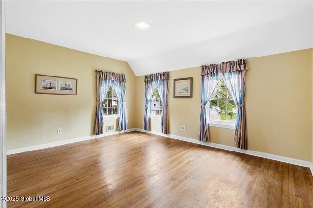 42 Pheasant Ridge Dr, Colonie, NY 12211 - empty room featuring wood finished floors, vaulted ceiling, and baseboards