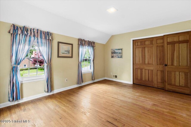42 Pheasant Ridge Dr, Colonie, NY 12211 - unfurnished bedroom with vaulted ceiling, light wood finished floors, baseboards, and multiple windows