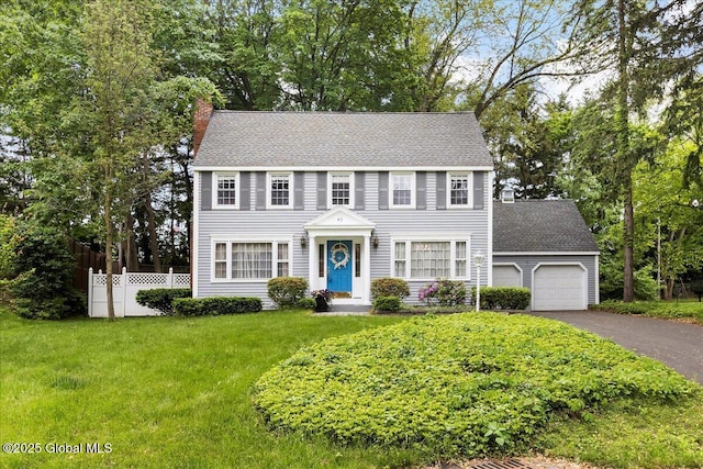 42 Pheasant Ridge Dr, Colonie, NY 12211 - colonial home with a chimney, a garage, asphalt driveway, and a shingled roof