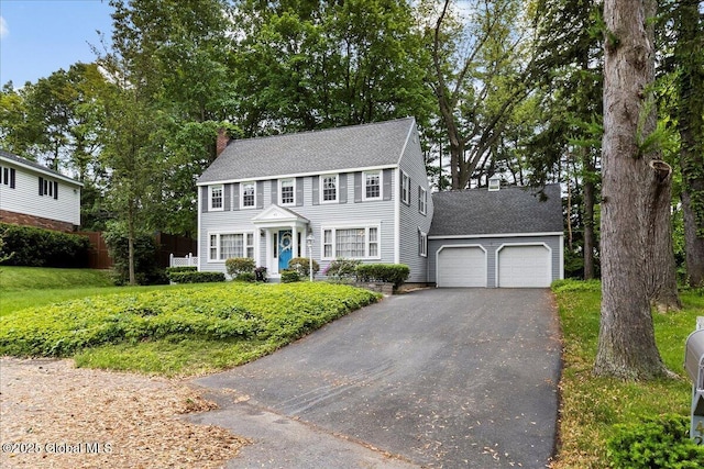 42 Pheasant Ridge Dr, Colonie, NY 12211 - colonial-style house featuring asphalt driveway, an attached garage, a chimney, and a shingled roof