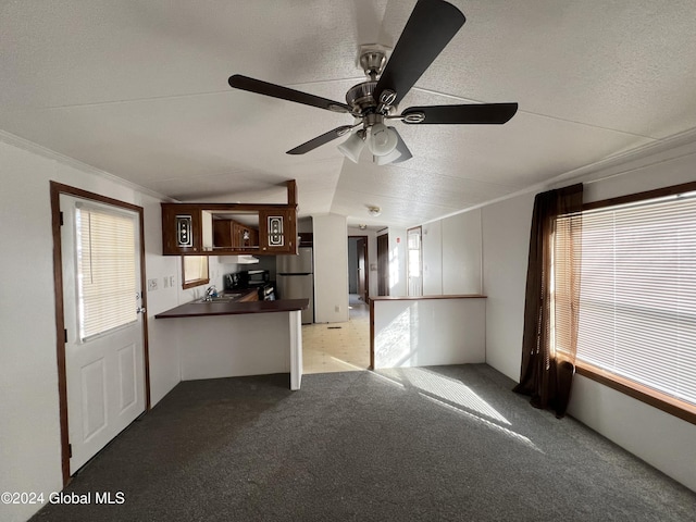 66 Plains Rd, Jackson, NY 12816 - kitchen with freestanding refrigerator, dark countertops, a peninsula, carpet flooring, and ceiling fan