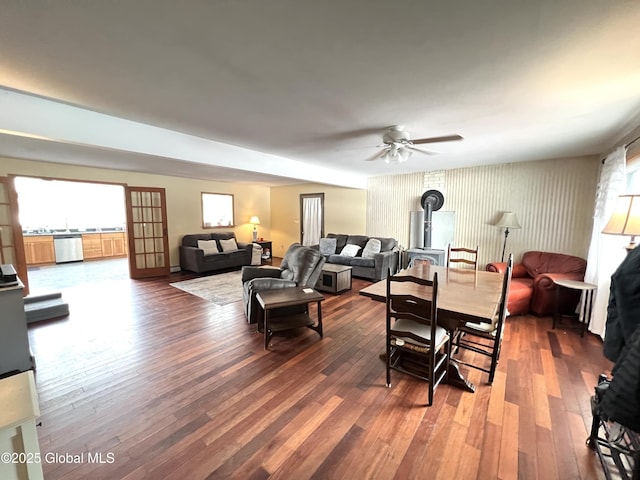 667-669 Ash Grove Rd, White Creek, NY 12816 - living room with a ceiling fan, wood-type flooring, plenty of natural light, and a wood stove