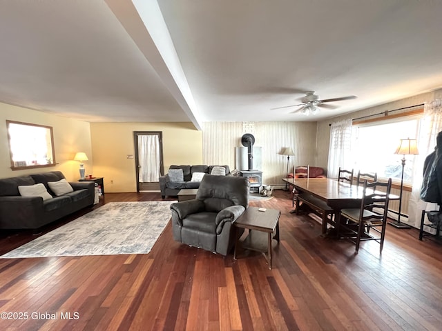 667-669 Ash Grove Rd, White Creek, NY 12816 - living area featuring a wood stove, dark wood finished floors, and a ceiling fan