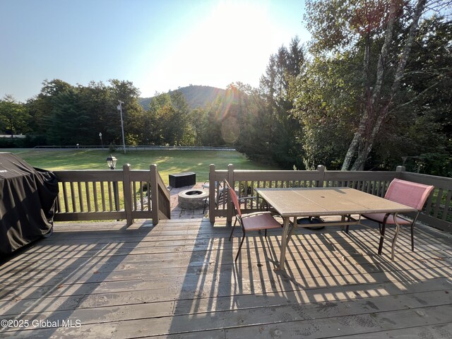 667-669 Ash Grove Rd, White Creek, NY 12816 - deck with a fire pit, a lawn, a mountain view, and outdoor dining space