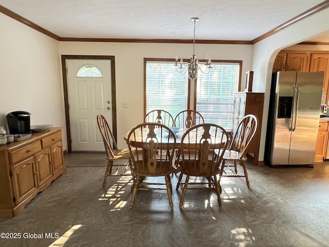 667-669 Ash Grove Rd, White Creek, NY 12816 - dining space featuring ornamental molding, arched walkways, and a chandelier