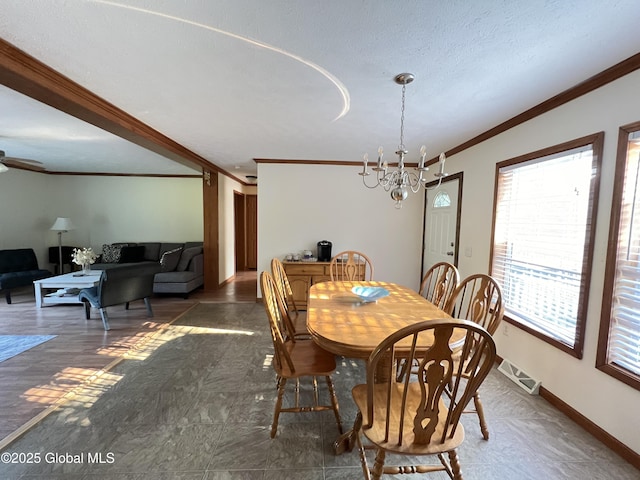 667-669 Ash Grove Rd, White Creek, NY 12816 - dining space with ornamental molding, a chandelier, baseboards, a ceiling fan, and a textured ceiling