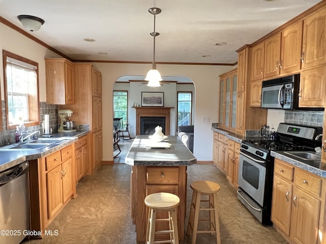 667-669 Ash Grove Rd, White Creek, NY 12816 - kitchen featuring appliances with stainless steel finishes, arched walkways, a center island, a sink, and backsplash